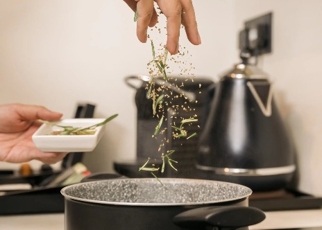 Person cooking in Dao by Dorsett AMTD Singapore room kitchenette