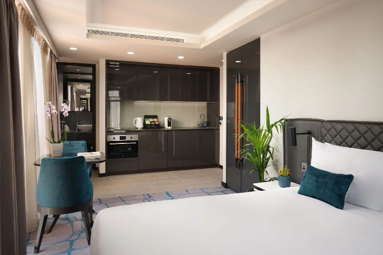 Bed, table and kitchenette in the Dao Studio Corner, West London.